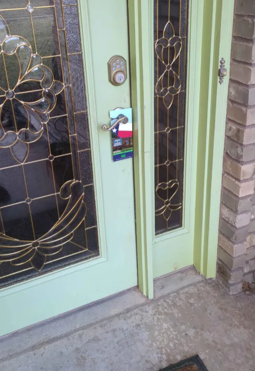 Door hanger placed on a residential front door